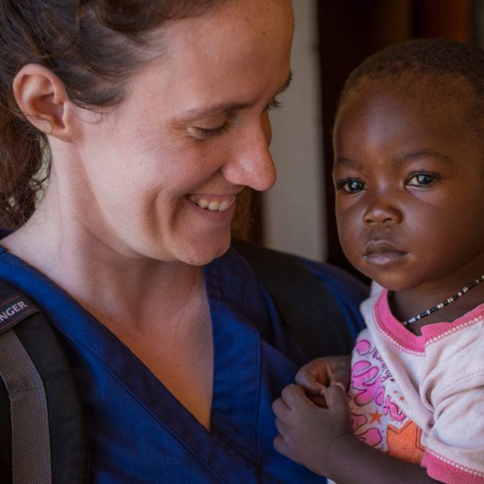 Volunteer Sarah Rubino holding a young girl in South Sudan in October 2018.