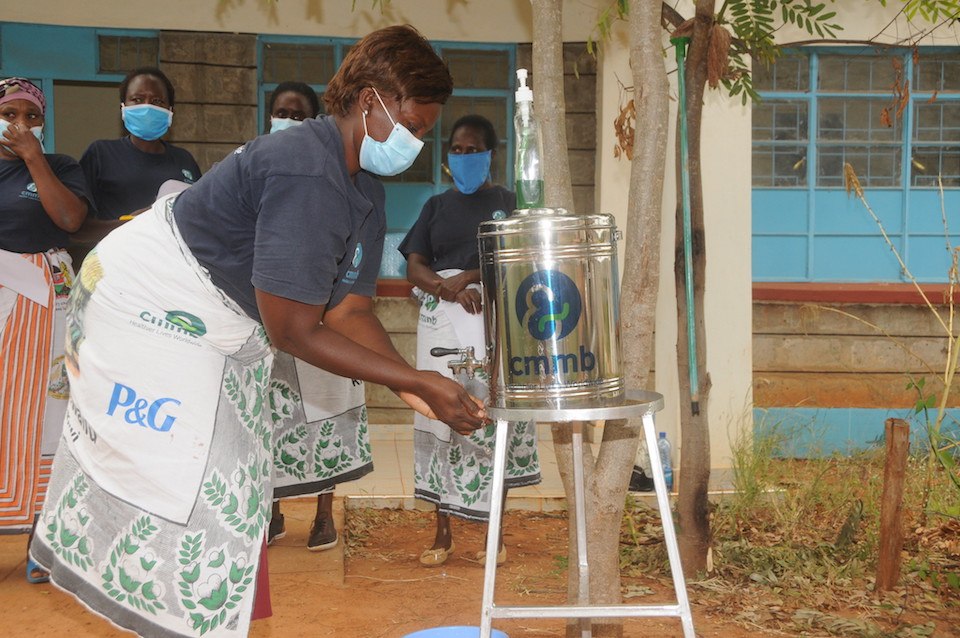 A woman washes her hands as a part of CMMB's COVID-19 response in Kenya in June 2018
