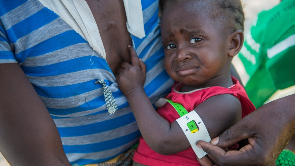 A child's arm being measured for red zone malnutriton in Mwandi in Zambia in October 2019.