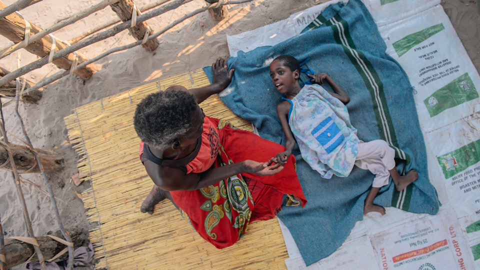 A grandmother and her grandaughter who is disabled and malnourished in Mwandi, Zambia in October 2019.