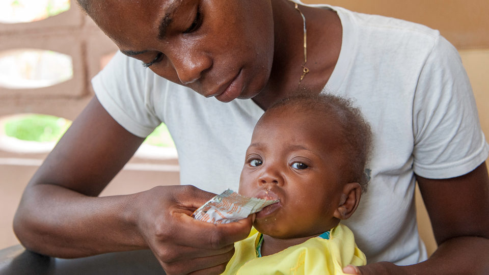 Mother-Child-Malnutrition-Plumpy-Nut-Cotes-de-Fer-Haiti-July-2018 A mother feeding her child nutritional Plumpy'Nut in Cotes de Fer, Haiti in July 2018.