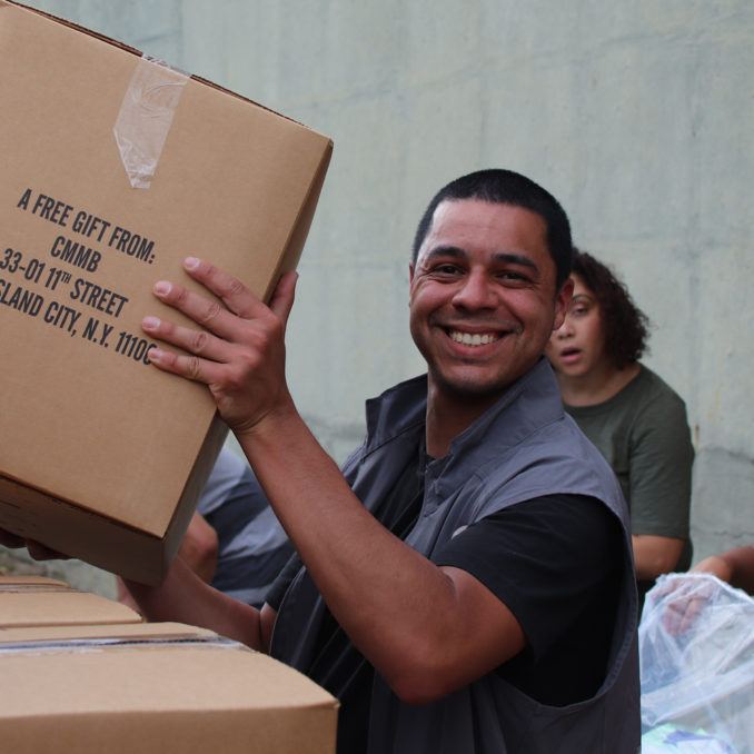 Medical Donations Program logistics staff member holding a box relief during a kitting event at the distribution center in New York in October 2019.