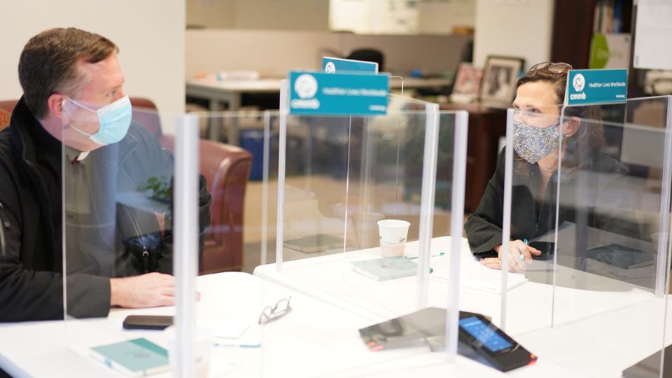 Father Matt Malone and Mary Beth Powers meet at CMMB's New York City headquarters in November 2020.