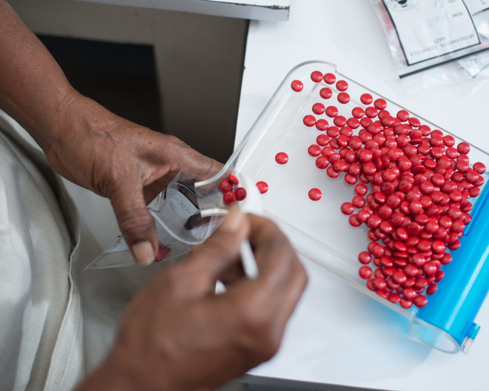 A pharmacist sorting medicines at a pharmacy in Haiti in July 2017.