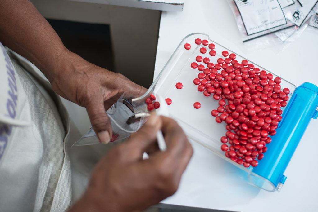 A pharmacist sorting medicines at a pharmacy in Haiti in July 2017.