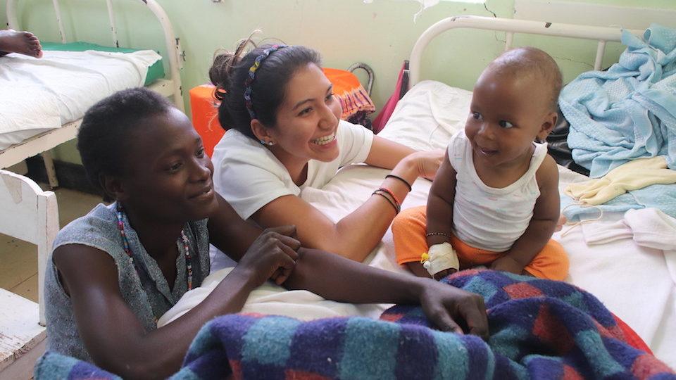 Samantha Hodge with a young patient in Kenya in 2019