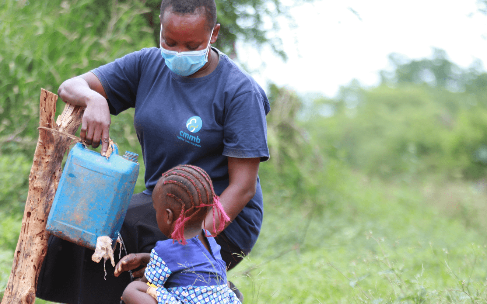 Community Health Worker Ndunge with child
