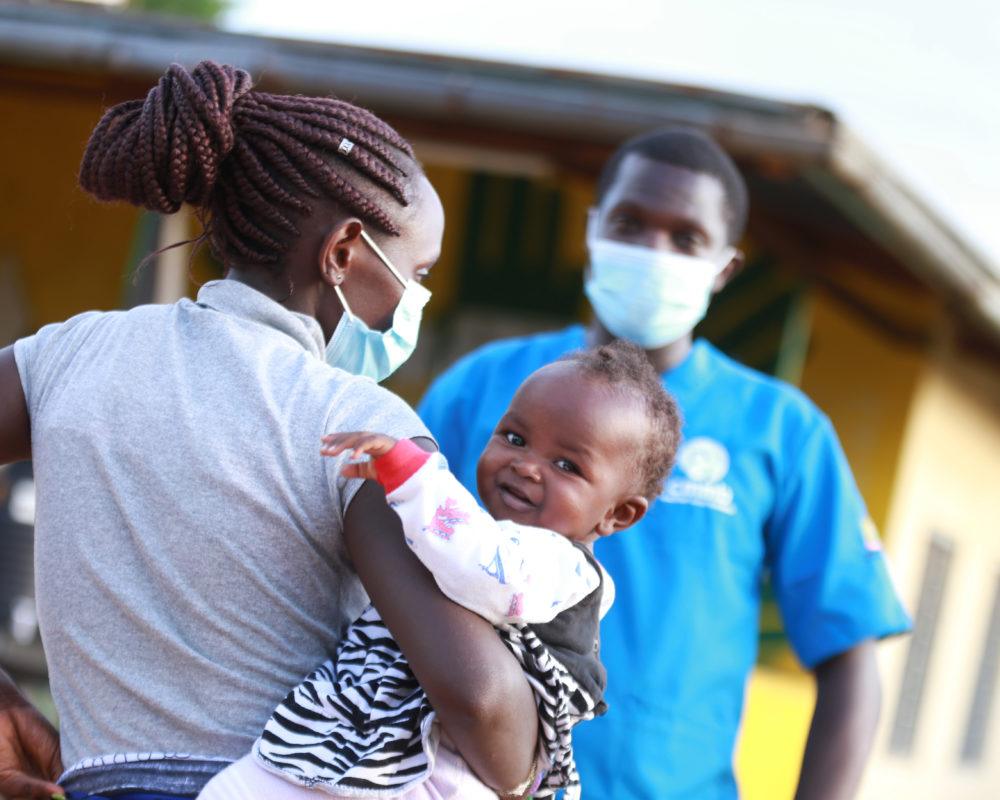 kenya health worker mom and child with community health worker