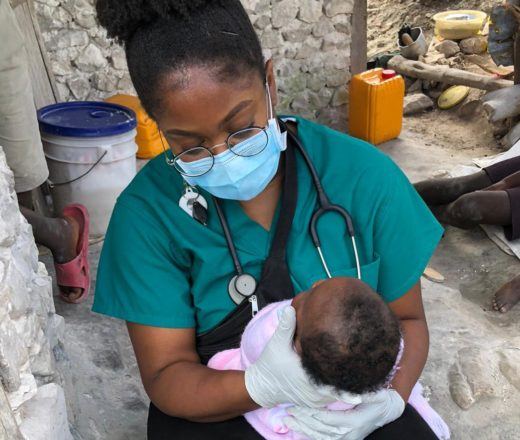 Stephanie-Onoho-Volunteer-Nurse-Hait-Cotes-de-Fer-March-2021 Volunteer nurse Stephanie Onoho holding an infant in Haiti in March 2021.