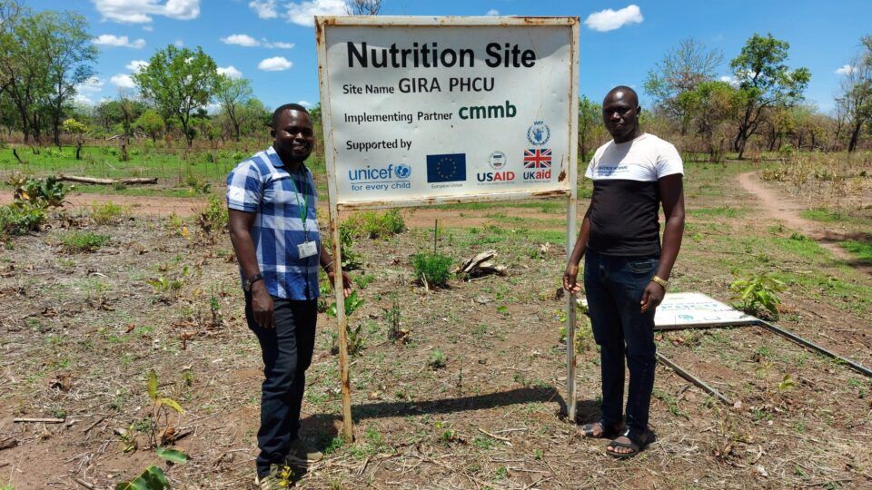 william and colleague in front of nutrition site