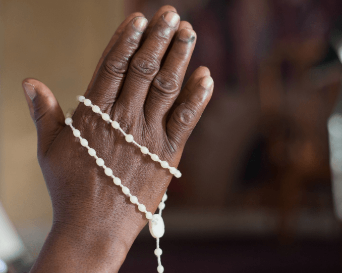 hands with rosary in prayer