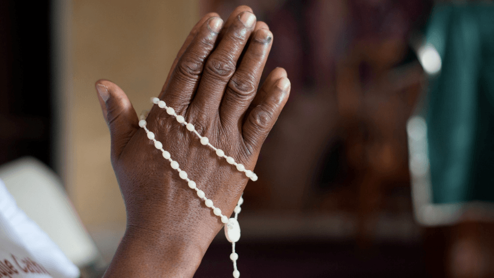 hands with rosary in prayer