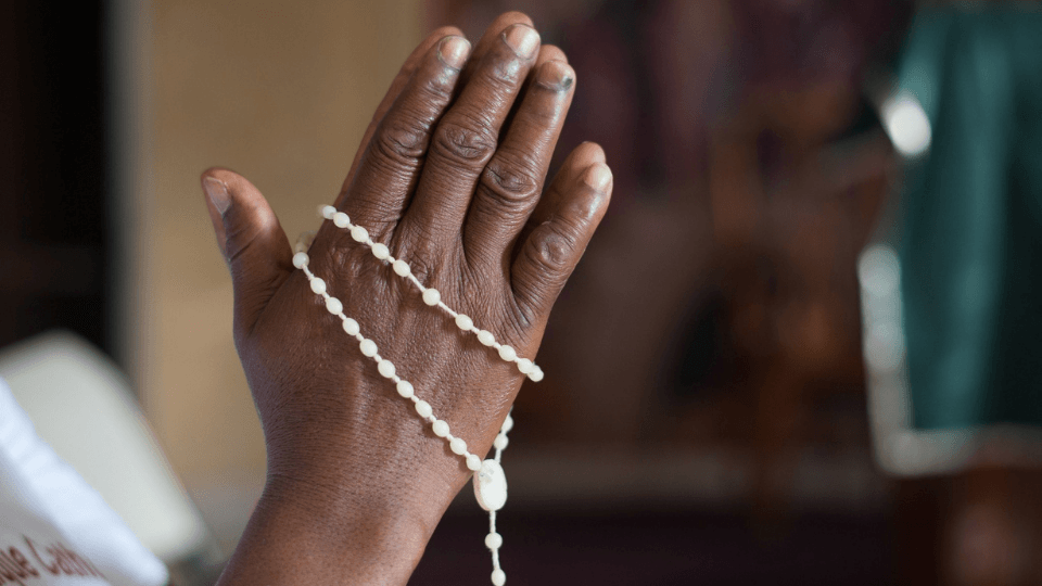 hands with rosary in prayer
