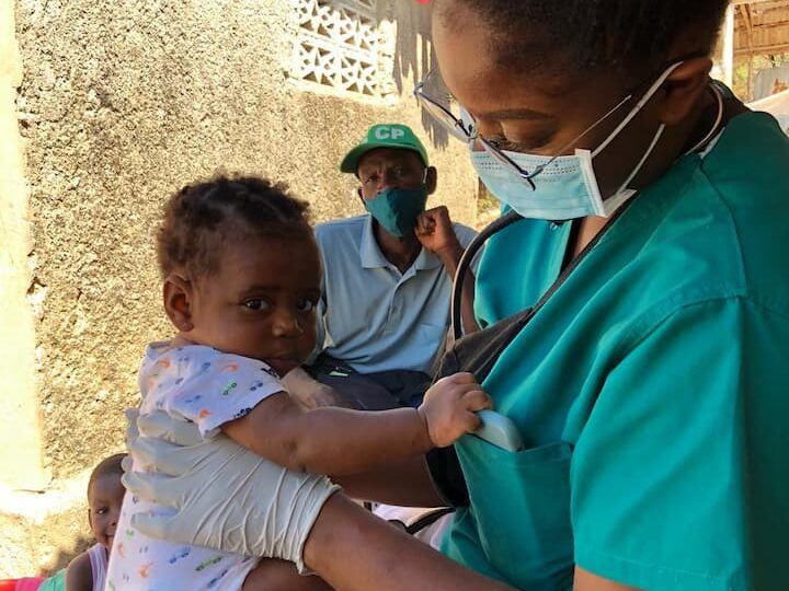 stephanie volunteer cares for baby in haiti