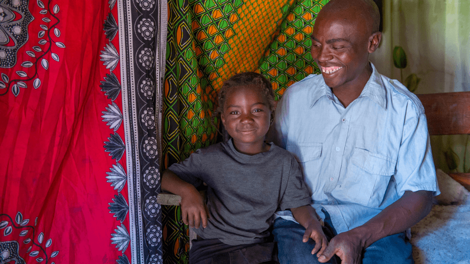 child with father at home in mwandi zambia
