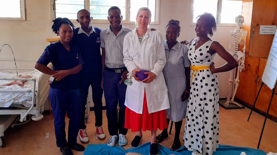 CMMB volunteer nurse educator Susan Stringham with students in Kenya in April 2022.