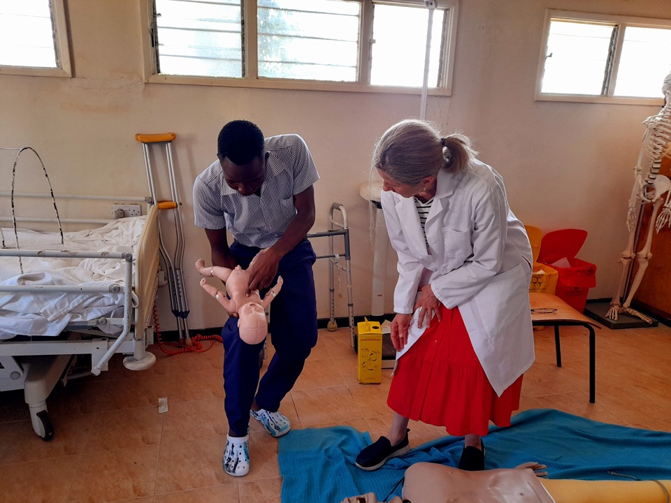 CMMB volunteer and nurse educator Susan Stringham with a student during a CPR training in rural Kenya in April 2022.