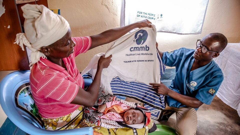 Mother holds new blanket for her newborn at the maternal health ward in Kenya_March2022
