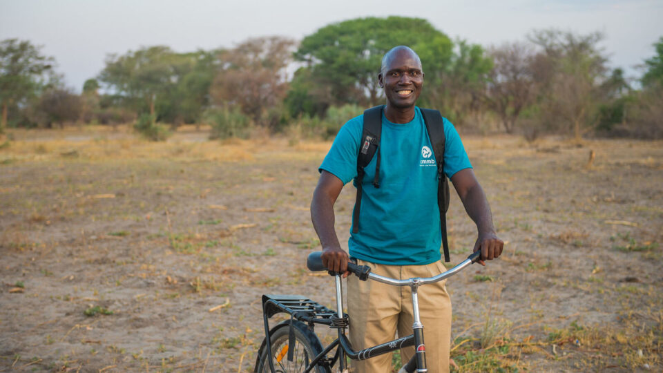 CMMB community health worker reaches patients by bike_June2022