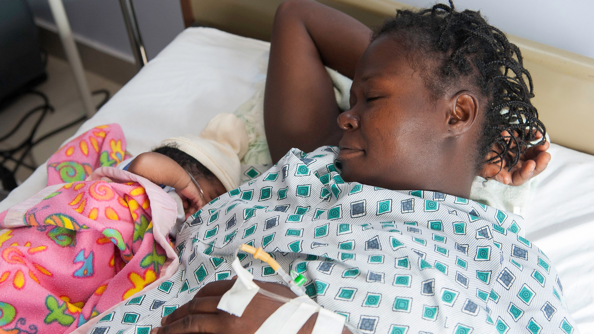 A mother rests beside her new baby at a hospital in Haiti_june2022