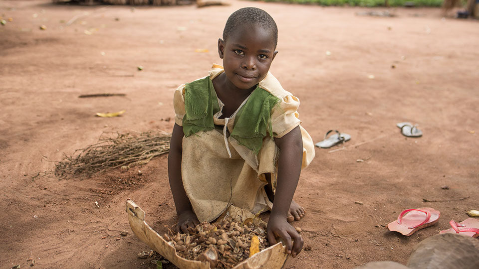 Young child in South Sudan kneels on the ground_CMMB_Oct2022