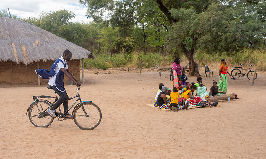 A community health worker joins a health clinic by bike_CMMB Zambia_2022