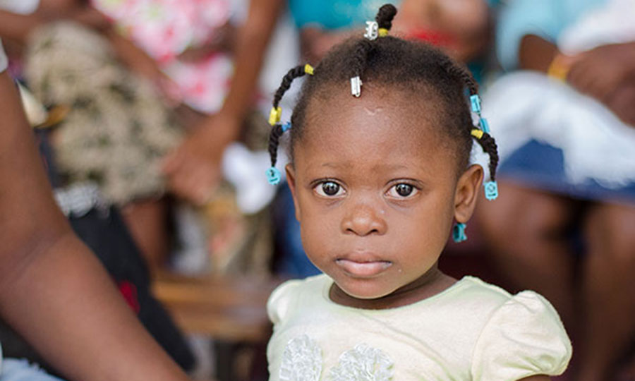 A young child receives vaccination in Haiti