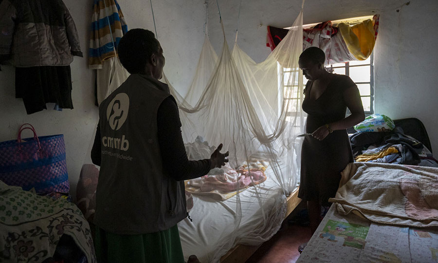 A community health promoter provides counsel for a mother in her community unit. 