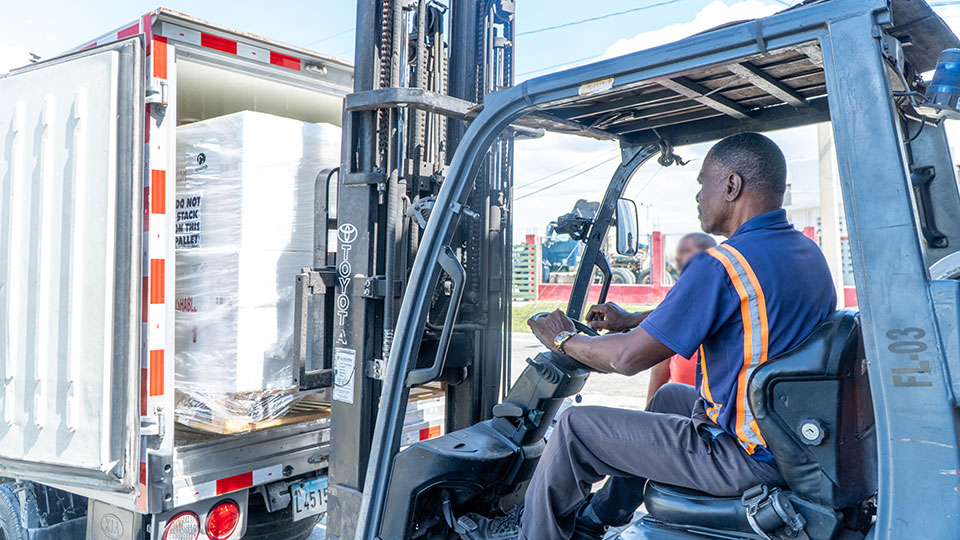 Medicala donations to treat cancer patients are unloaded from a truck. CMMB and Cross Catholic Outreach partner to deliver these donations to those who need them most.