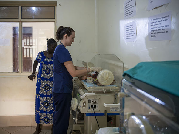 Volunteer Sarah Rubio cares for a newborn baby in the newborn room at St. Theresa Hospital. 