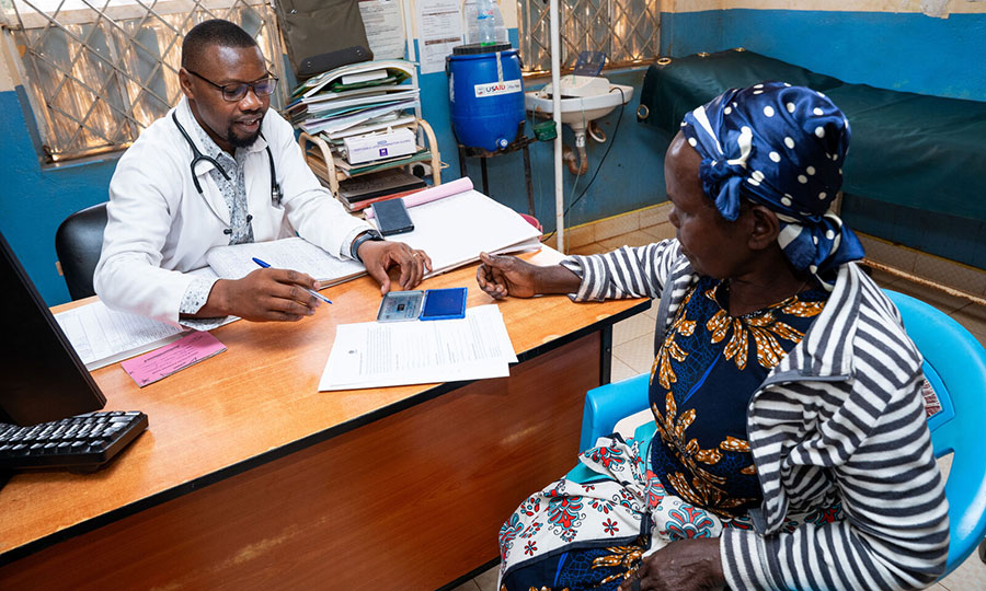 Clinical officer Eliud and patient Kandy at teh Miambhani health center in Kenya.