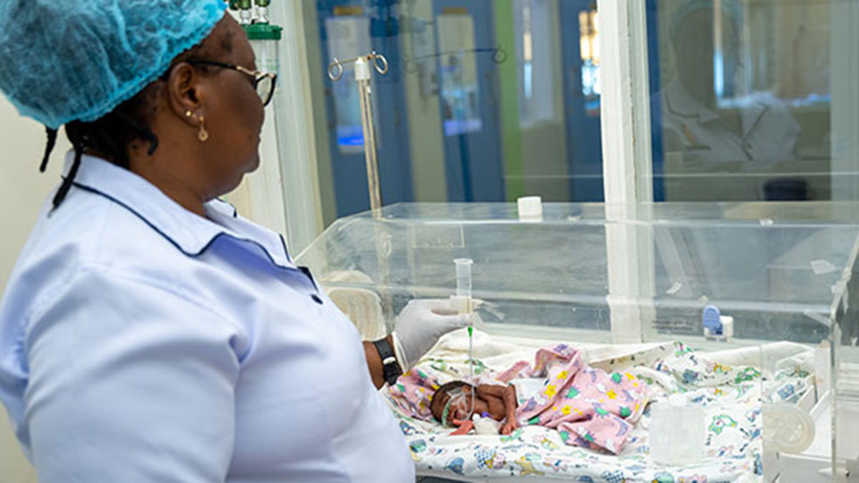 Nurse Irene with a newborn