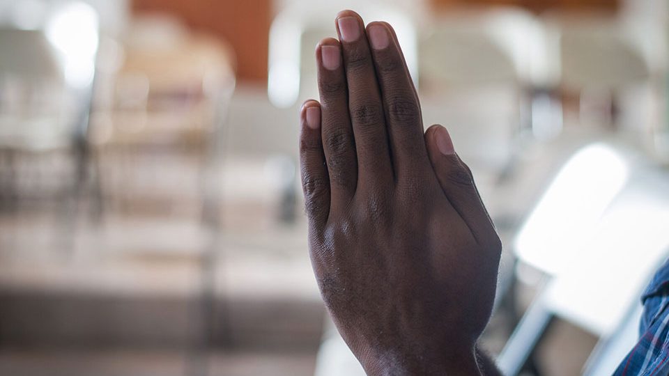 Hands praying. This image is the featured image of a blog post about Hansen's disease