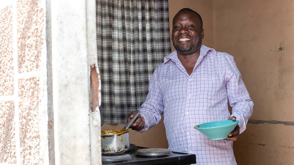 Jonas prepares a meal for his family.