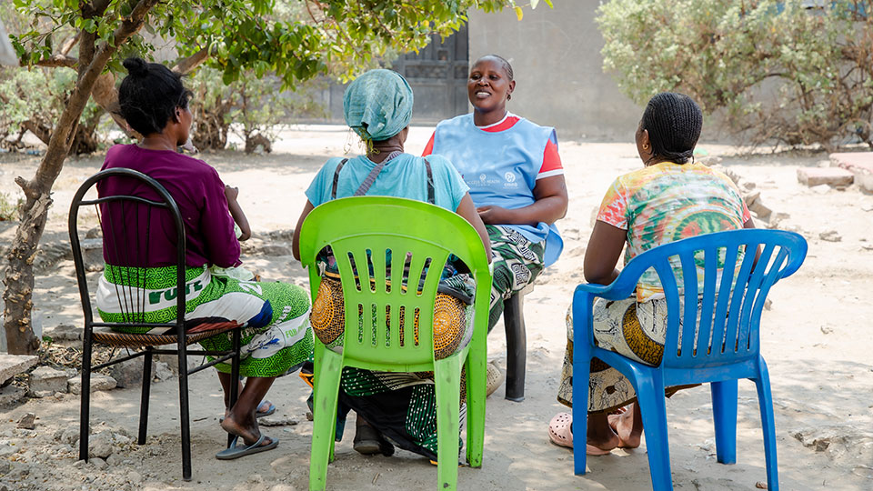 Community health worker Charity meets with community members to talk about cervical cancer prevention.