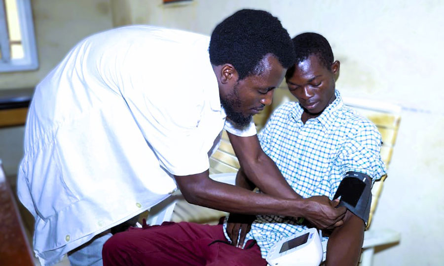 A patient has his blood pressure checked at CTK hospital.