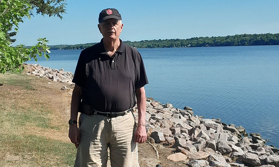 Cletus, a cmmb donor, in front of a body of water.
