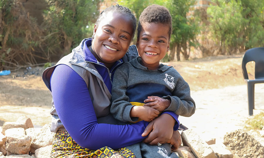 Prisca visits a community member enrolled in the Kusumala Project.
