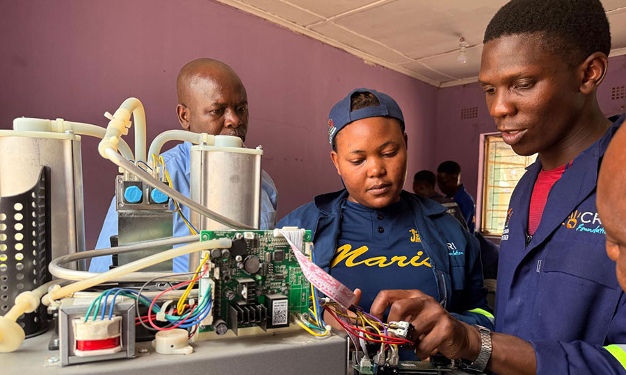 A group of engineers work to repair equipment at the Mwandi Mission Hospital in Zambia.