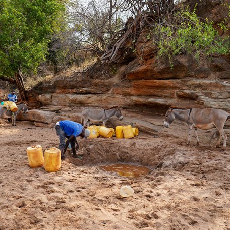 community-member-collecting-water-from-shallow-well